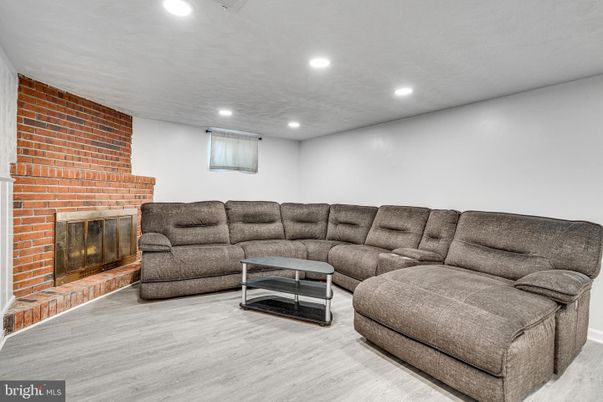 Fireplace, Interior, Living room, Recessed Lighting, Stone Walls, Wood Texture Flooring