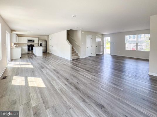 Empty room, Interior, Kitchen, Recessed Lighting, Stainless Steel Appliances, Wood Texture Flooring