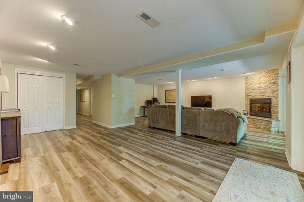 Fireplace, Interior, Living room, Recessed Lighting, Stone Walls, Wood Texture Flooring