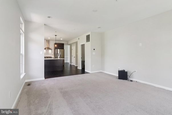 Empty room, Interior, Kitchen, Pendant Lights, Recessed Lighting, Stainless Steel Appliances, Wood Texture Flooring