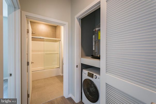 Bathroom, Glass Shower, Interior, Utility Closets, Washer, Wood Texture Flooring