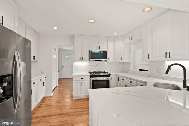 Interior, Kitchen, Marble Walls, Recessed Lighting, Stainless Steel Appliances, Wood Texture Flooring
