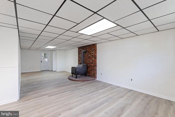 Empty room, Fireplace, Interior, Recessed Lighting, Stone Walls, Wood Texture Flooring