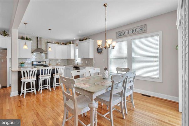 Chandelier, Dining room, Interior, Kitchen, Pendant Lights, Recessed Lighting, Stainless Steel Appliances, Wood Texture Flooring