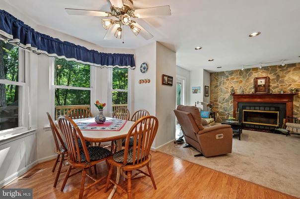 Dining room, Fireplace, Interior, Living room, Recessed Lighting, Stone Walls, Wood Texture Flooring