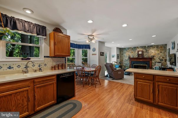 Dining room, Fireplace, Interior, Kitchen, Living room, Recessed Lighting, Stone Walls, Wood Texture Flooring