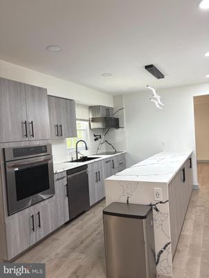 Interior, Kitchen, Marble Walls, Pendant Lights, Recessed Lighting, Stainless Steel Appliances, Wood Texture Flooring