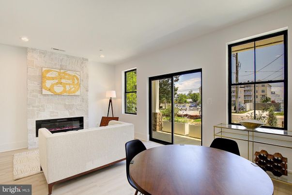 Dining room, Fireplace, Interior, Living room, Recessed Lighting, Stone Walls, Wood Texture Flooring