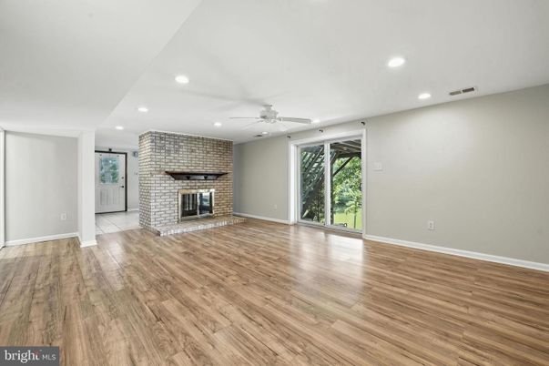 Empty room, Fireplace, Interior, Recessed Lighting, Stone Walls, Wood Texture Flooring