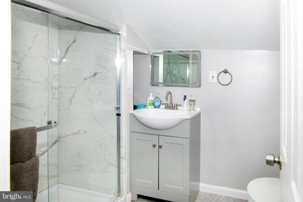 Bathroom, Glass Shower, Interior, Marble Walls, Wood Texture Flooring