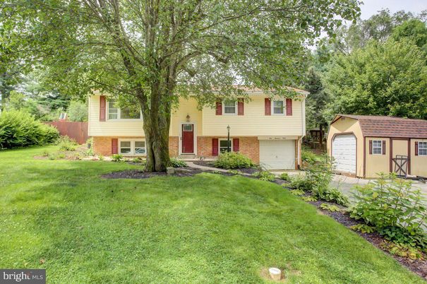 Attached, Backyard, Exterior, Facade, Brick Facade, Raised Ranch