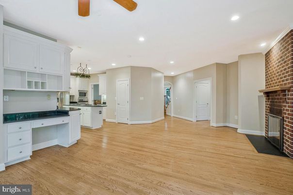 Fireplace, Interior, Kitchen, Recessed Lighting, Stainless Steel Appliances, Stone Walls, Wood Texture Flooring