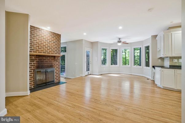 Empty room, Fireplace, Interior, Recessed Lighting, Stone Walls, Wood Texture Flooring