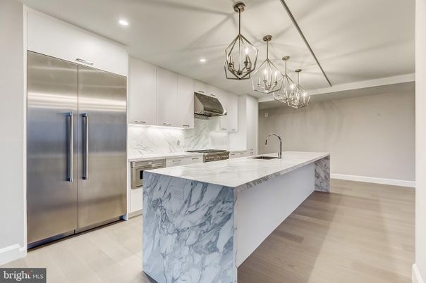 Chandelier, Interior, Kitchen, Marble Walls, Pendant Lights, Recessed Lighting, Stainless Steel Appliances, Wood Texture Flooring