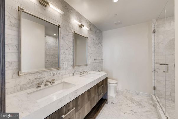 Bathroom, Dual Sink Vanities, Glass Shower, Interior, Marble, Marble Walls, Recessed Lighting