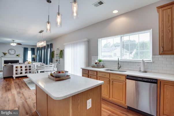 Dining room, Fireplace, Interior, Kitchen, Living room, Pendant Lights, Recessed Lighting, Stainless Steel Appliances, Wood Texture Flooring