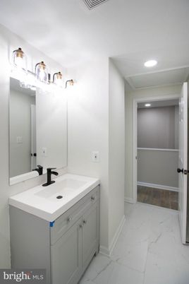 Bathroom, Dual Sink Vanities, Interior, Marble, Recessed Lighting, Wood Texture Flooring