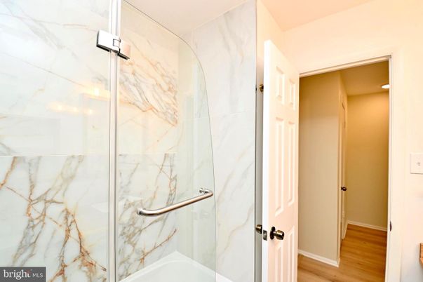 Bathroom, Glass Shower, Interior, Marble Walls, Wood Texture Flooring