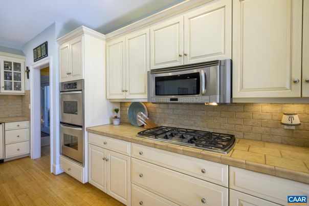 Interior, Kitchen, Recessed Lighting, Stainless Steel Appliances, Tile Countertops, Wood Texture Flooring