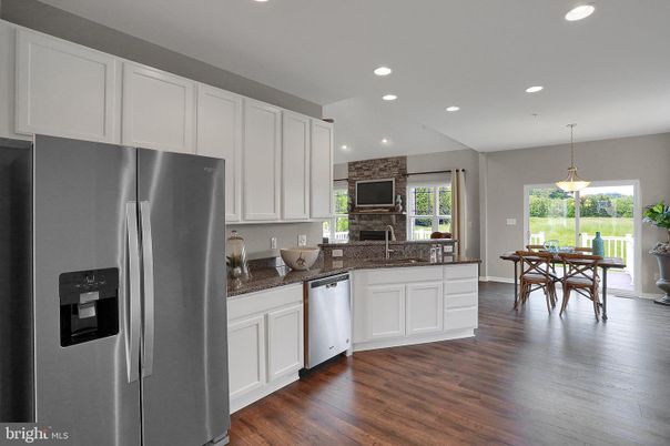 Dining room, Fireplace, Interior, Kitchen, Pendant Lights, Recessed Lighting, Stainless Steel Appliances, Stone Walls, Wood Texture Flooring