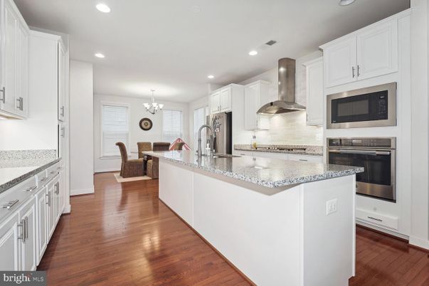 Chandelier, Dining room, Interior, Kitchen, Recessed Lighting, Stainless Steel Appliances, Wood Texture Flooring