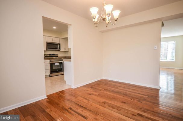 Chandelier, Empty room, Interior, Kitchen, Recessed Lighting, Stainless Steel Appliances, Wood Texture Flooring