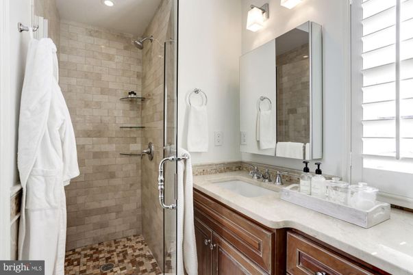 Bathroom, Dual Sink Vanities, Glass Shower, Interior, Recessed Lighting, Stone Walls