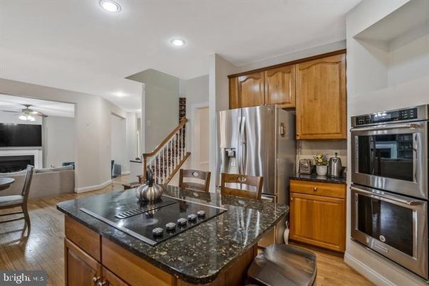 Dining room, Fireplace, Interior, Kitchen, Living room, Recessed Lighting, Stainless Steel Appliances, Wood Texture Flooring