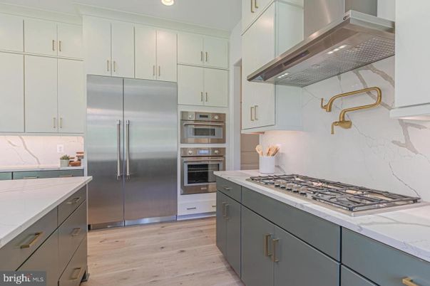 Interior, Kitchen, Marble Walls, Recessed Lighting, Stainless Steel Appliances, Wood Texture Flooring