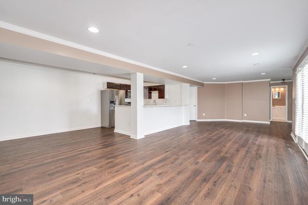 Empty room, Interior, Kitchen, Recessed Lighting, Stainless Steel Appliances, Wood Texture Flooring