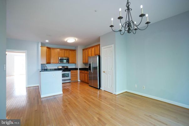 Chandelier, Empty room, Interior, Kitchen, Recessed Lighting, Stainless Steel Appliances, Wood Texture Flooring