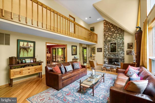Fireplace, Interior, Living room, Recessed Lighting, Stone Walls, Wood Texture Flooring