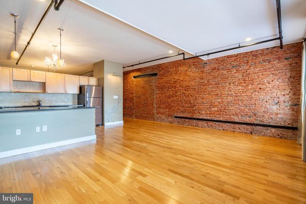 Chandelier, Empty room, Interior, Kitchen, Pendant Lights, Recessed Lighting, Stainless Steel Appliances, Stone Walls, Wood Texture Flooring