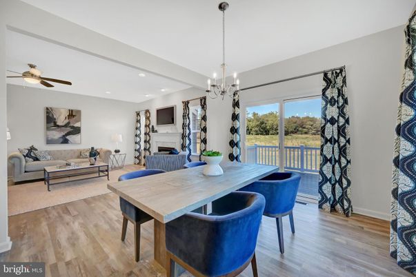 Chandelier, Dining room, Fireplace, Interior, Living room, Pendant Lights, Recessed Lighting, Wood Texture Flooring
