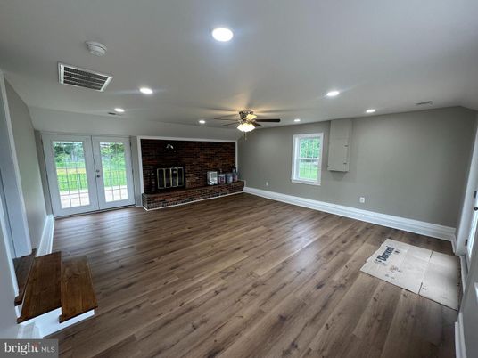 Empty room, Fireplace, Interior, Recessed Lighting, Stone Walls, Wood Texture Flooring