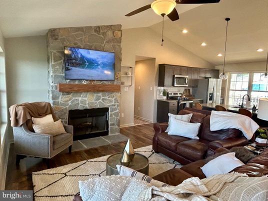 Fireplace, Interior, Kitchen, Living room, Pendant Lights, Recessed Lighting, Stainless Steel Appliances, Stone Walls, Wood Texture Flooring