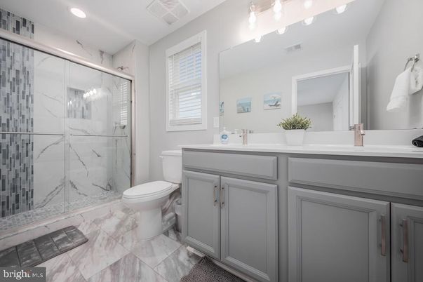 Bathroom, Dual Sink Vanities, Glass Shower, Interior, Marble, Marble Walls, Recessed Lighting