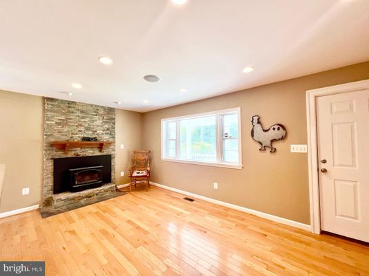 Empty room, Fireplace, Interior, Recessed Lighting, Stone Walls, Wood Texture Flooring