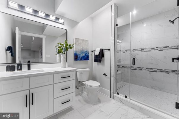 Bathroom, Dual Sink Vanities, Glass Shower, Interior, Marble, Marble Walls, Recessed Lighting