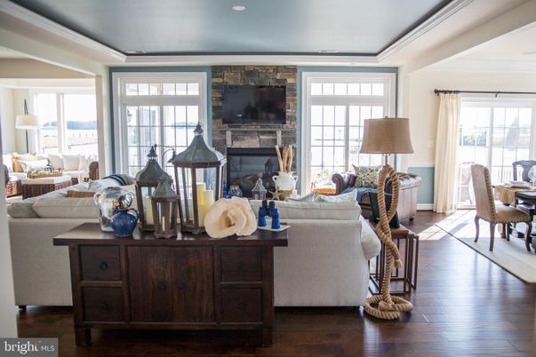 Dining room, Fireplace, Interior, Living room, Recessed Lighting, Stone Walls, Wood Texture Flooring