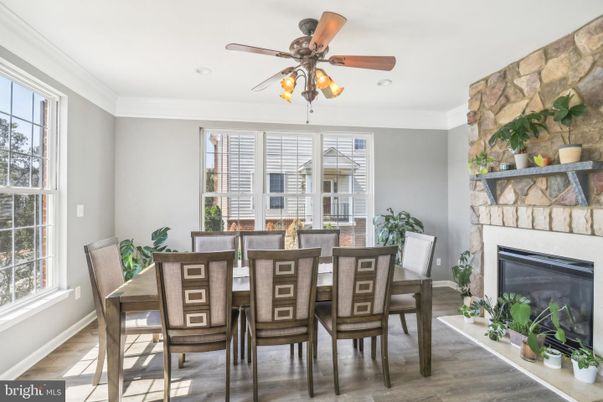 Dining room, Fireplace, Interior, Recessed Lighting, Stone Walls, Wood Texture Flooring