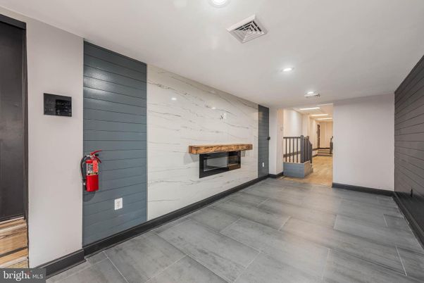Fireplace, Interior, Marble Walls, Recessed Lighting, Wood Texture Flooring