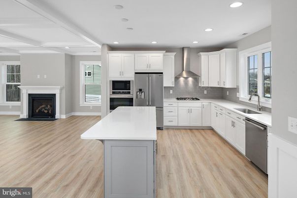 Fireplace, Interior, Kitchen, Recessed Lighting, Stainless Steel Appliances, Wood Texture Flooring