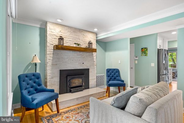 Fireplace, Interior, Living room, Recessed Lighting, Stone Walls, Wood Texture Flooring