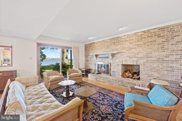 Fireplace, Interior, Living room, Recessed Lighting, Stone Walls, Water, Wood Texture Flooring