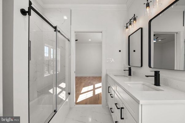 Bathroom, Dual Sink Vanities, Glass Shower, Interior, Marble, Marble Walls, Recessed Lighting, Wood Texture Flooring