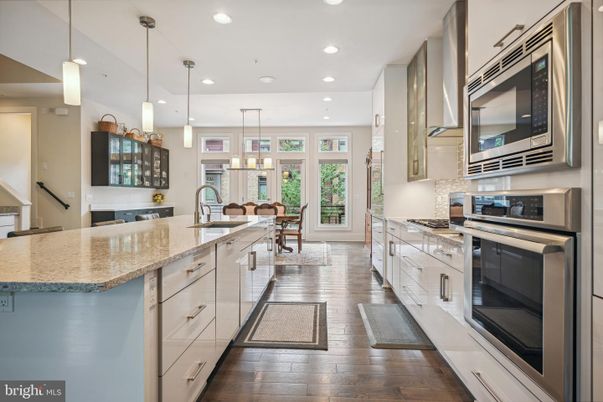 Chandelier, Dining room, Interior, Kitchen, Pendant Lights, Recessed Lighting, Stainless Steel Appliances, Wood Texture Flooring