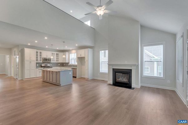 Empty room, Fireplace, Interior, Kitchen, Pendant Lights, Recessed Lighting, Stainless Steel Appliances, Wood Texture Flooring