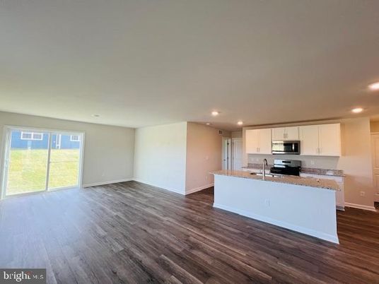 Empty room, Interior, Kitchen, Recessed Lighting, Stainless Steel Appliances, Wood Texture Flooring