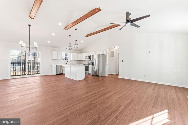 Empty room, Interior, Kitchen, Pendant Lights, Recessed Lighting, Stainless Steel Appliances, Wooden Beams, Wood Texture Flooring